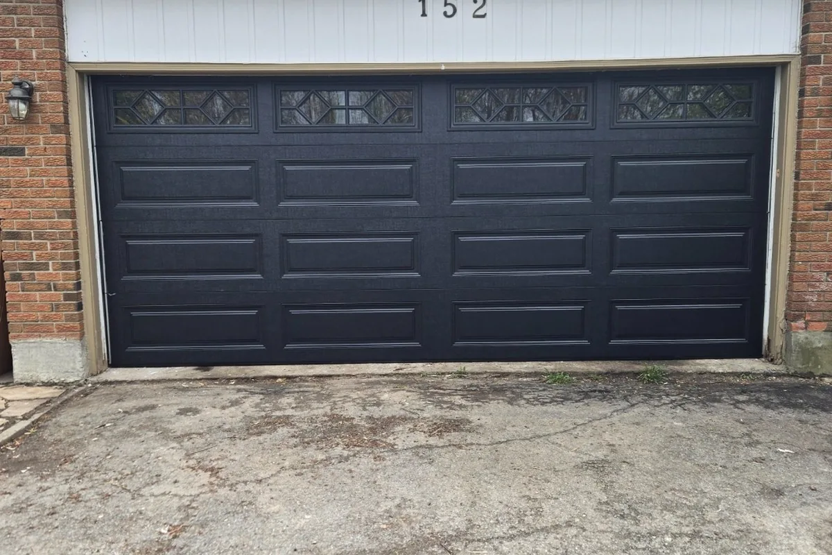 Modern Orléans home with a charcoal insulated double garage door
